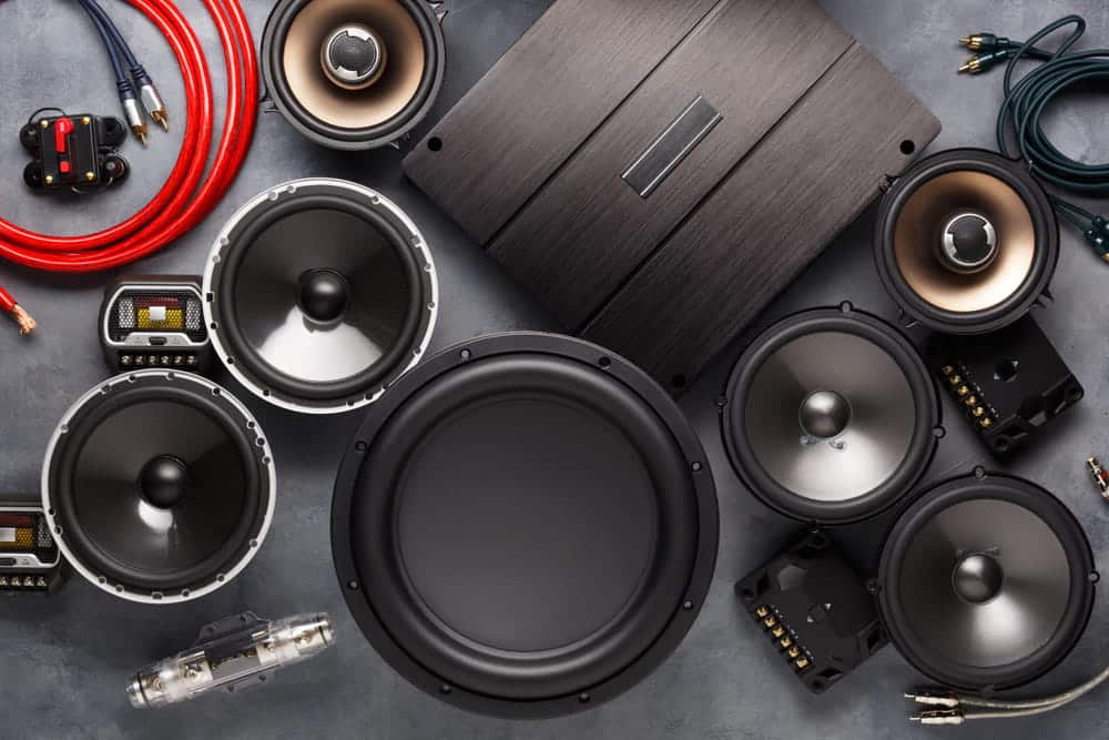 Installed car audio speakers and amplifier for enhanced in-car sound performance